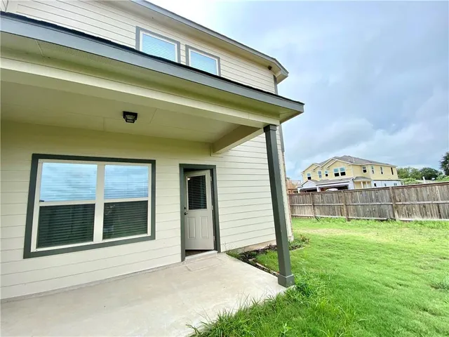 a view of a house with a yard and sitting area