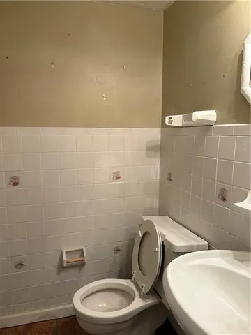 a bathroom with a toilet a sink and shower