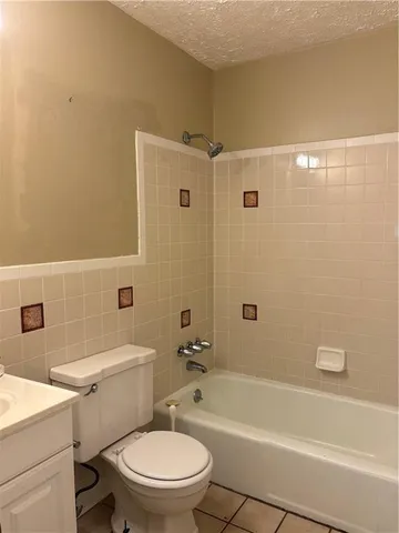 a bathroom with a toilet a sink and bathtub