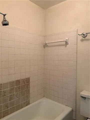 a bath tub sitting next to a white toilet