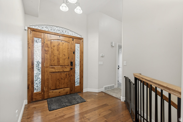 7296 Ridge Road Lake Point, UT 84074 - Photo 9 of 54 Entryway featuring a solid wood front door with decorative glass sidelights and transom