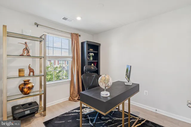 a view of a workspace with furniture and window