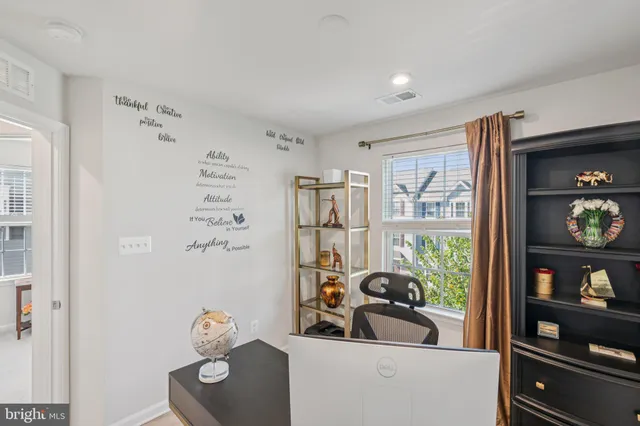 a view of a livingroom with furniture workspace and a window