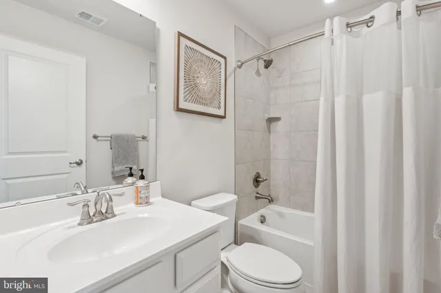 a bathroom with a sink toilet a mirror and shower
