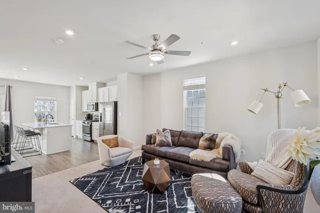 a living room with furniture and kitchen view