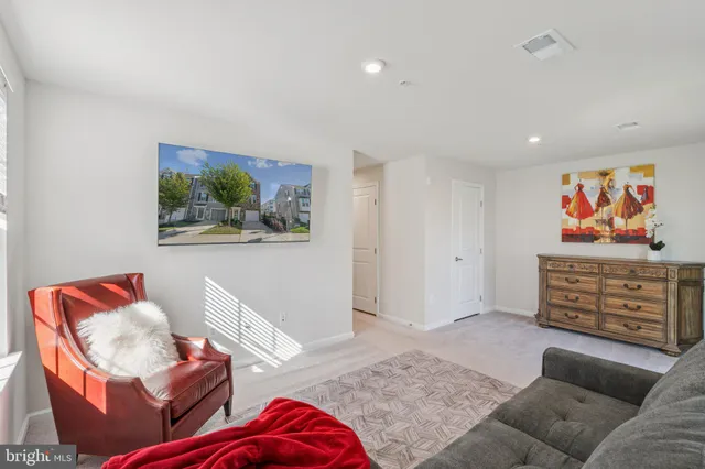 a living room with furniture window and a wooden floor