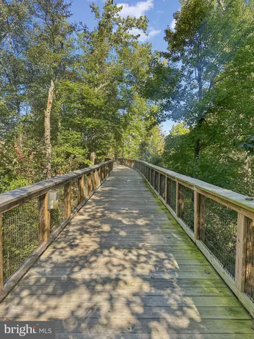 a view of balcony with wooden floor and fence