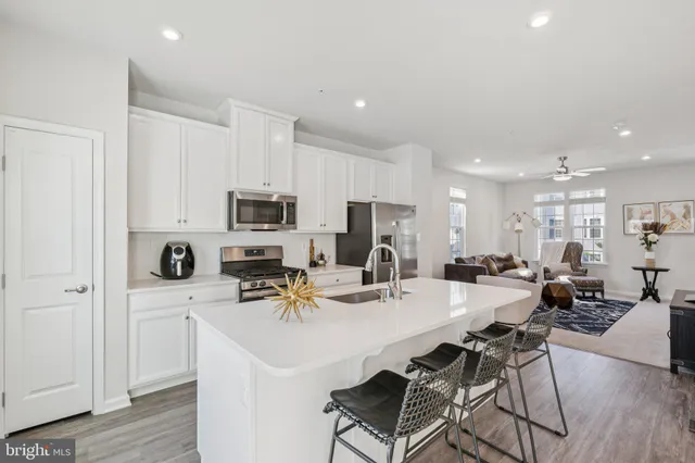 a kitchen with stainless steel appliances a refrigerator and a stove top oven