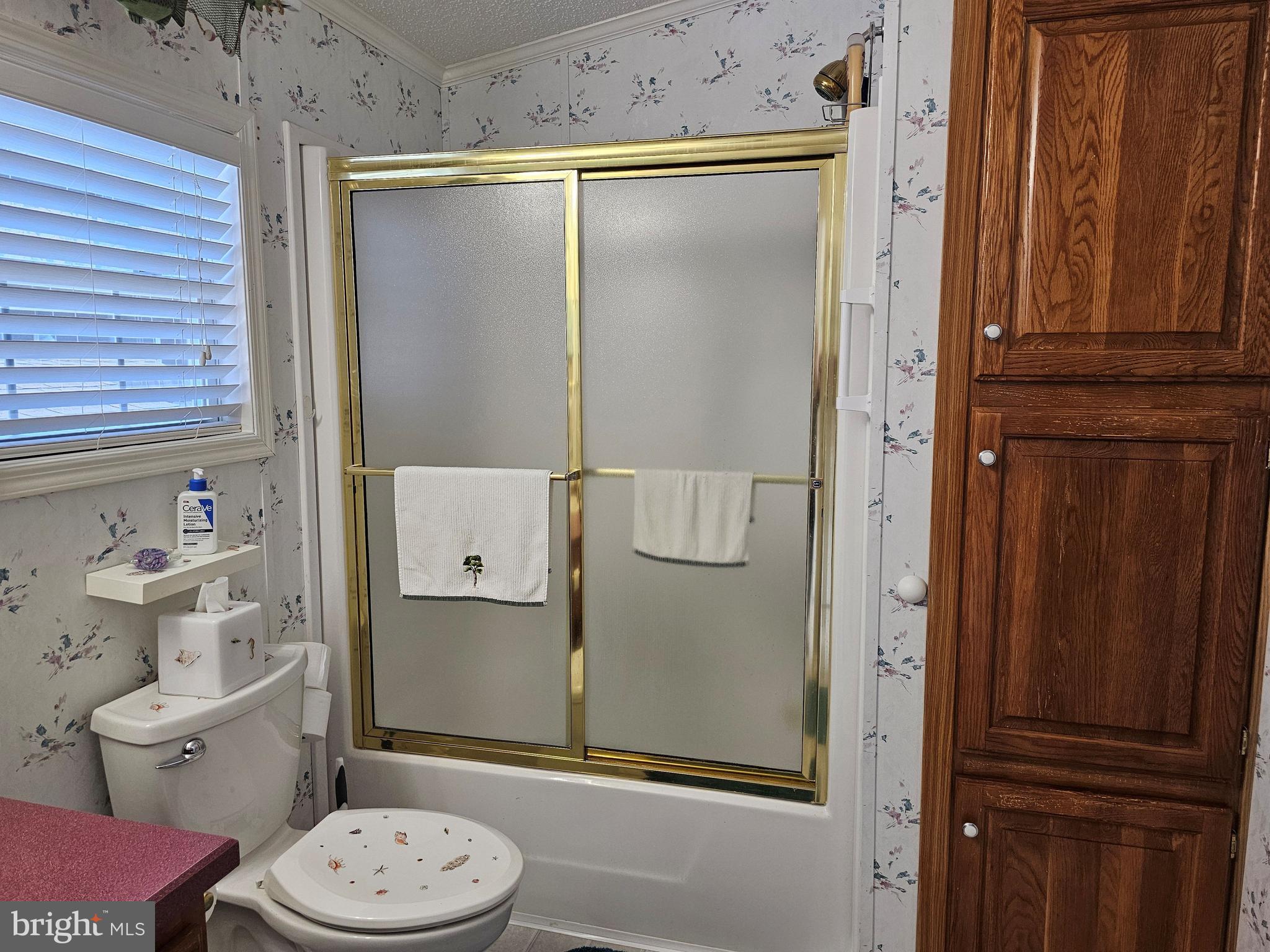 136 Salt Spray Drive Berlin, MD 21811 - Photo 21 of 39 a bathroom with a granite countertop toilet and a shower