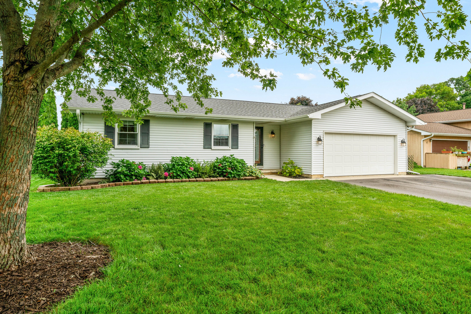 1108 Bittersweet Drive Plano, IL 60545 - Photo 1 of 45 a front view of a house with a garden