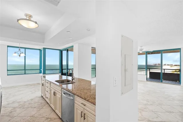 a kitchen with stainless steel appliances granite countertop a sink stove and microwave