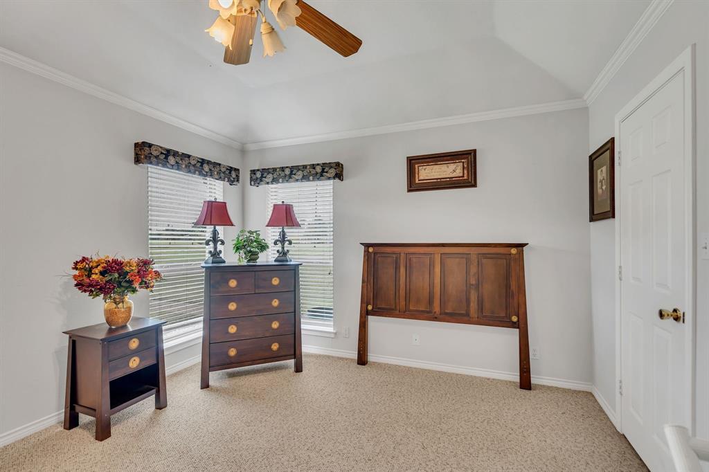 50 Buckingham Lane Allen, TX 75002 - Photo 30 of 39 Bedroom with light colored carpet, crown molding, and a ceiling fan