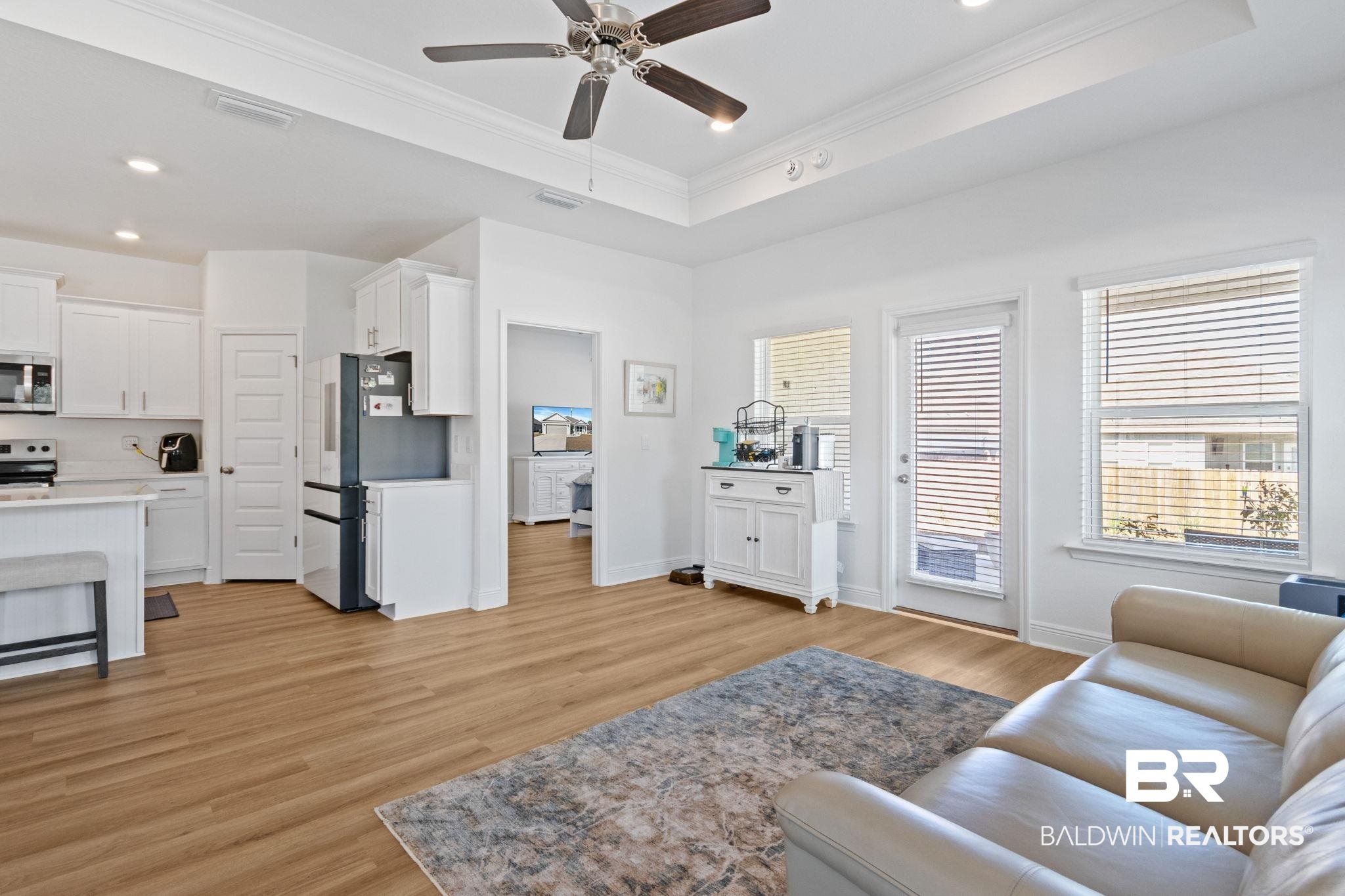 12919 Torrent Road Fairhope, AL 36532 - Photo 21 of 74 Living room with crown molding, a ceiling fan, light wood-style floors, a raised ceiling, and recessed lighting