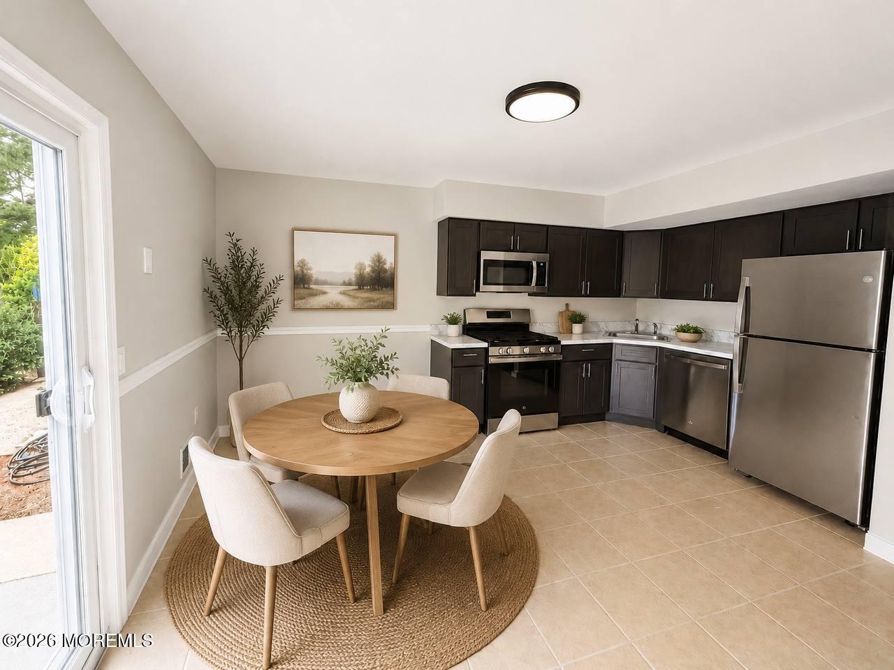 1144 Sawmill Road, Unit 121 Brick, NJ 08724 - Photo 10 of 23 a kitchen with stainless steel appliances granite countertop a dining table and chairs