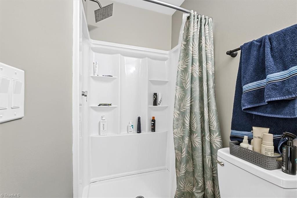 226 Friendly Avenue High Point, NC 27260 - Photo 20 of 38 The ensuite bathroom in the primary suite includes a rain style shower head and full tub and shower combination. Please note this suite is unpermitted and full seller disclosures are available.