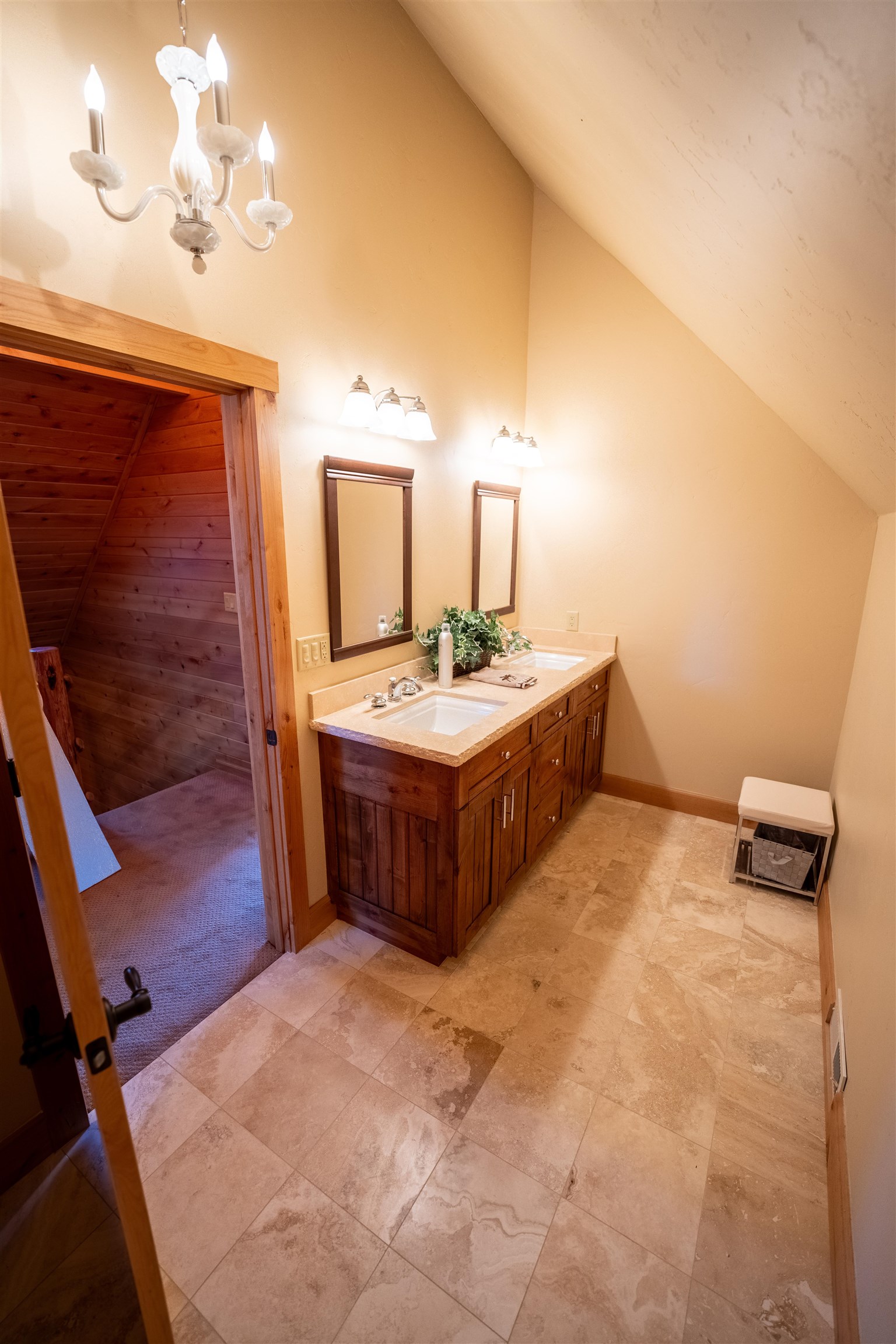 14942 Donner Pass Road Truckee, CA 96161 - Photo 20 of 21 a spacious bedroom with a bed and a chandelier