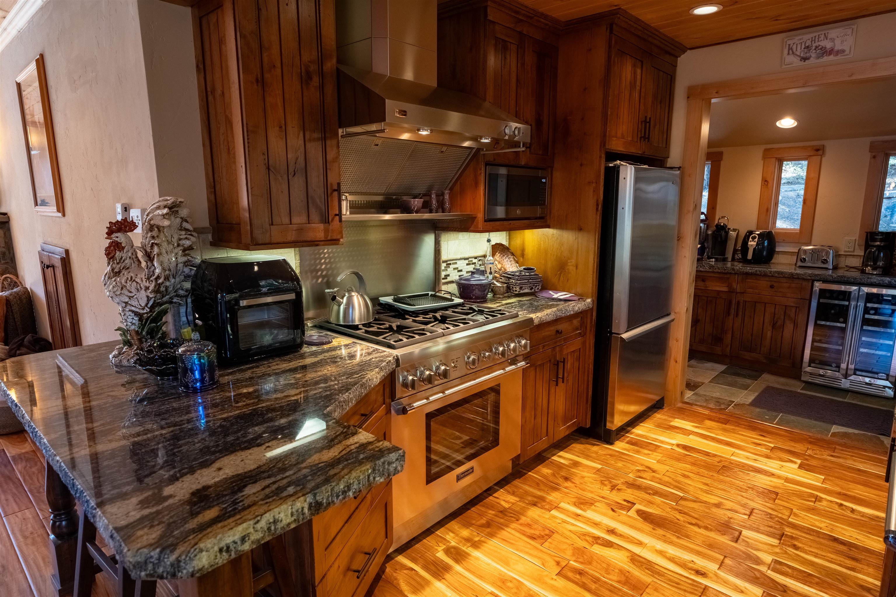 14942 Donner Pass Road Truckee, CA 96161 - Photo 5 of 21 a kitchen with stainless steel appliances granite countertop a stove a sink and a refrigerator