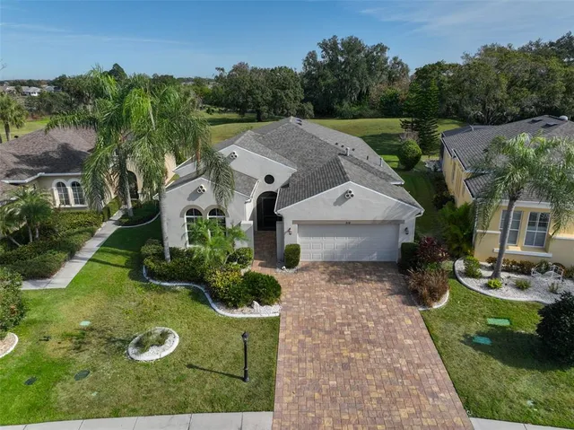 aerial view of a house with yard and green space