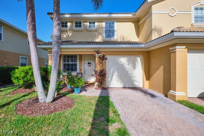 20012 Heatherstone Way, Unit 1 Estero, FL 33928 - Photo 1 of 48 a front view of a house with a porch