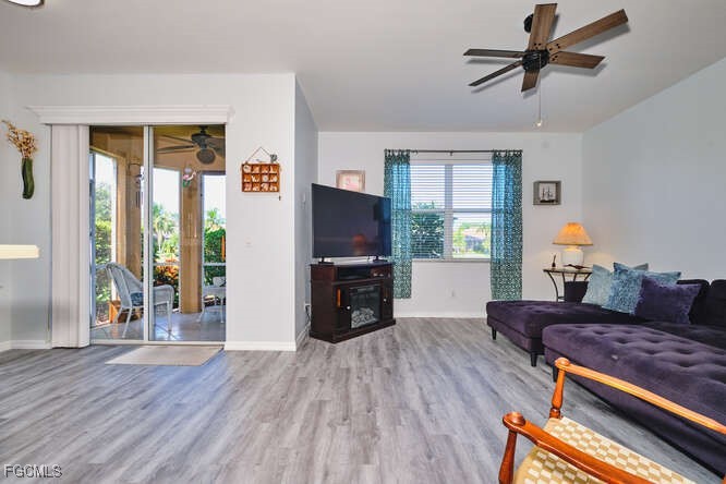20012 Heatherstone Way, Unit 1 Estero, FL 33928 - Photo 15 of 48 a living room with furniture and a flat screen tv