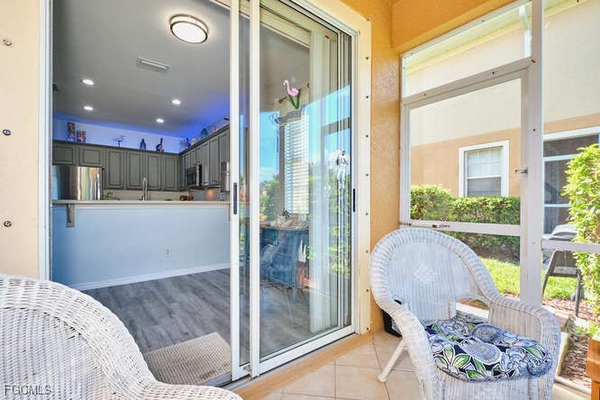 20012 Heatherstone Way, Unit 1 Estero, FL 33928 - Photo 18 of 48 a living room with a large window and furniture