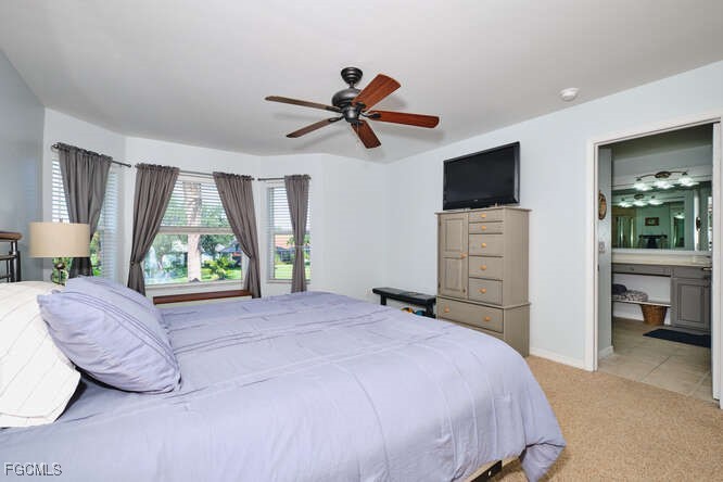 20012 Heatherstone Way, Unit 1 Estero, FL 33928 - Photo 20 of 48 a bedroom with a bed and a flat screen tv