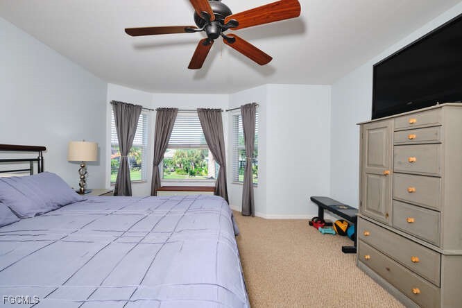 20012 Heatherstone Way, Unit 1 Estero, FL 33928 - Photo 21 of 48 a bedroom with a bed and a flat tv screen on dresser