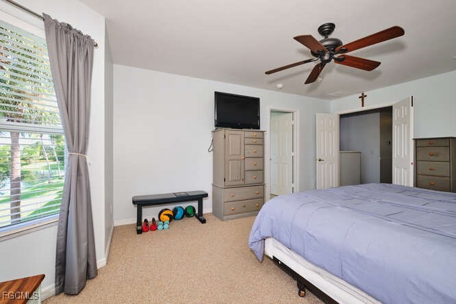 20012 Heatherstone Way, Unit 1 Estero, FL 33928 - Photo 22 of 48 a bedroom with a bed and a flat screen tv