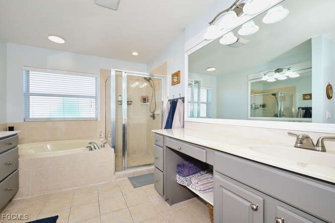 20012 Heatherstone Way, Unit 1 Estero, FL 33928 - Photo 23 of 48 a spacious bathroom with a shower a sink and a large mirror