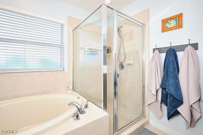 20012 Heatherstone Way, Unit 1 Estero, FL 33928 - Photo 27 of 48 a bathroom with a bathtub and a shower