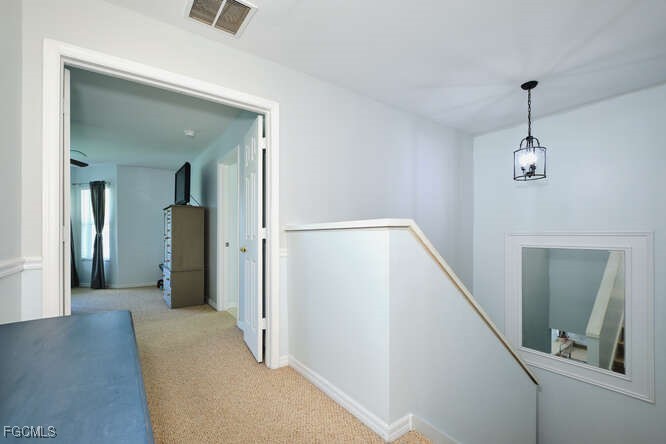 20012 Heatherstone Way, Unit 1 Estero, FL 33928 - Photo 29 of 48 a view of a hallway with wooden floor and staircase