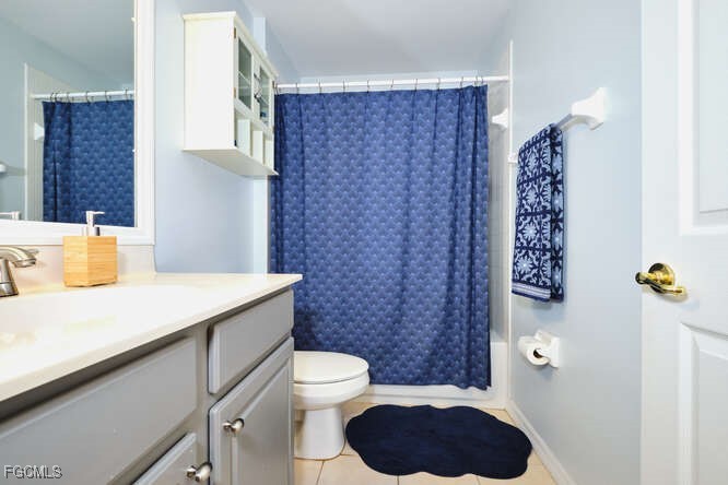 20012 Heatherstone Way, Unit 1 Estero, FL 33928 - Photo 35 of 48 a bathroom with a sink a toilet and shower curtain