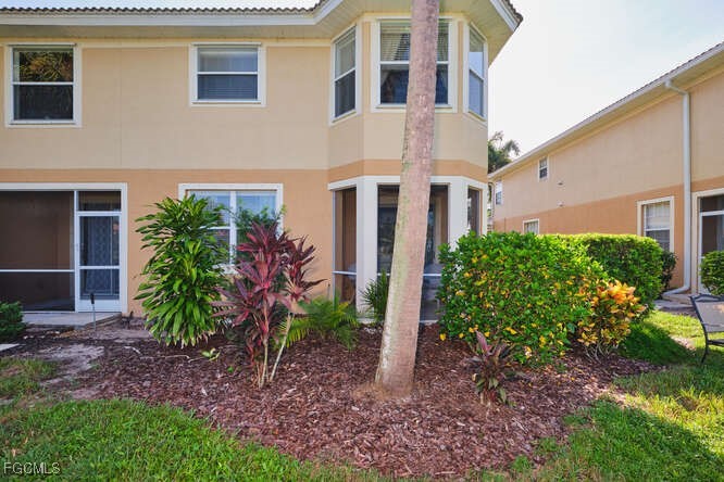 20012 Heatherstone Way, Unit 1 Estero, FL 33928 - Photo 40 of 48 a view of a house with backyard and garden