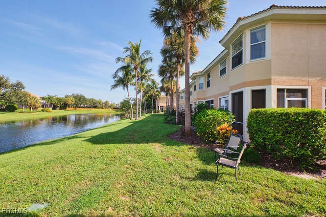 20012 Heatherstone Way, Unit 1 Estero, FL 33928 - Photo 41 of 48 a garden with a bench and lake view
