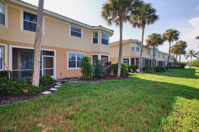 20012 Heatherstone Way, Unit 1 Estero, FL 33928 - Photo 42 of 48 a front view of house with yard and green space