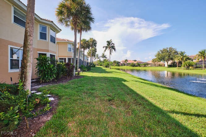 20012 Heatherstone Way, Unit 1 Estero, FL 33928 - Photo 43 of 48 a view of a lake with a house in the background