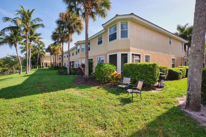 20012 Heatherstone Way, Unit 1 Estero, FL 33928 - Photo 44 of 48 a backyard of a house with outdoor seating and garden