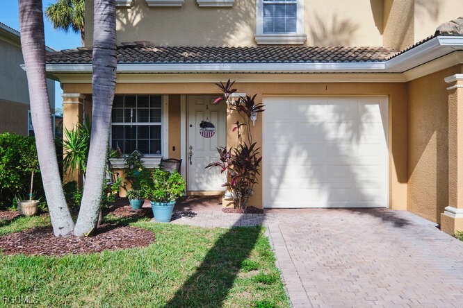 20012 Heatherstone Way, Unit 1 Estero, FL 33928 - Photo 48 of 48 a front view of a house with garden
