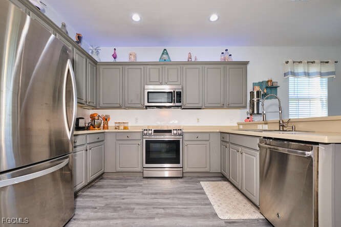 20012 Heatherstone Way, Unit 1 Estero, FL 33928 - Photo 5 of 48 a kitchen with stainless steel appliances granite countertop a refrigerator stove top oven and sink