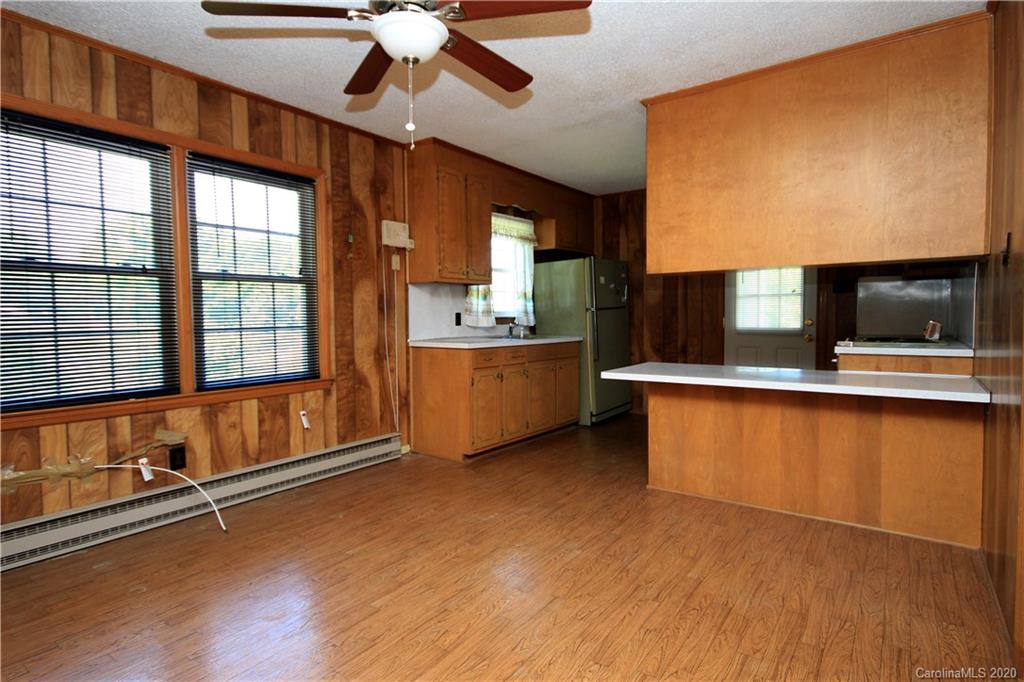 2688 South Potter Road Heath Springs, SC 29058 - Photo 4 of 12 a living room with stainless steel appliances kitchen island granite countertop a stove and a large window