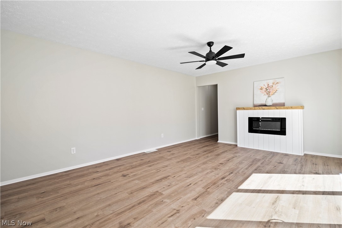 32969 Mills Road North Ridgeville, OH 44039 - Photo 5 of 29 Unfurnished living room featuring light hardwood / wood-style flooring and ceiling fan