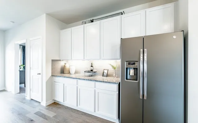 a kitchen with stainless steel appliances a refrigerator sink and cabinets