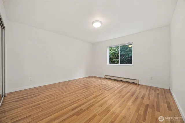 a view of a room with wooden floor and a sink