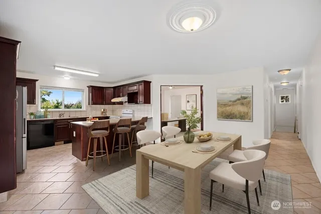 a dining room with furniture potted plants and wooden floor