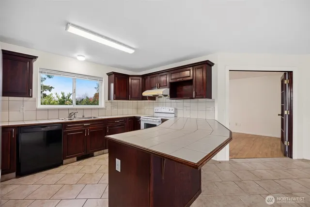 a kitchen with a sink stove and microwave