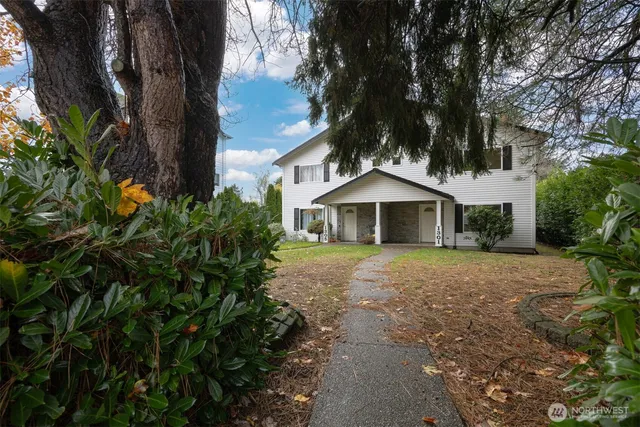 a kitchen with a sink a stove a refrigerator and white cabinets