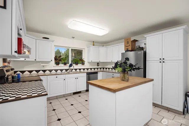 a kitchen with granite countertop a sink and cabinets