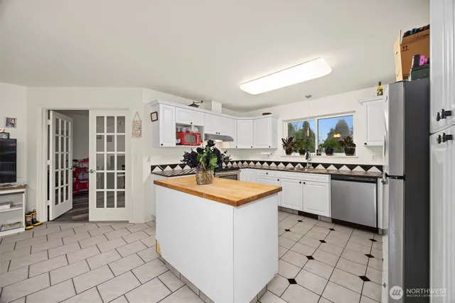 a kitchen with granite countertop cabinets and steel stainless steel appliances