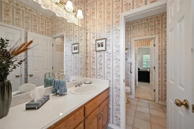 a bedroom with bed and a chandelier