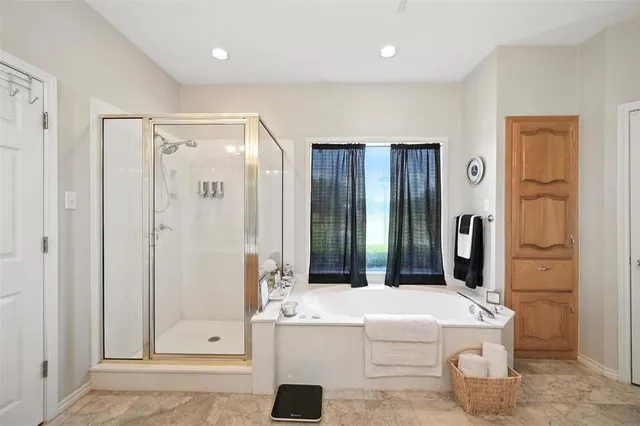 a large bathroom with a sink mirror and a bath tub